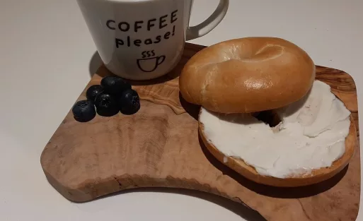 Cream cheese bagel and black coffee.